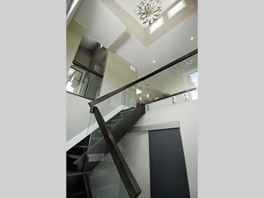 The McAllisters were impressed that builder Maple Leaf Custom Homes came in on budget (they declined to say what that was). However, says Jeff, “We didn’t.” After setting aside $2,000 for light fixtures, they spotted this dazzler for the stairwell at Multi Luminaire. The price tag was $2,100. There are no regrets, however. The light is the perfect complement for the dark-stained risers and railings, the glass panels and the chrome industrial-look hardware holding it all together.