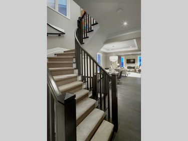 The staircase to the second floor is on a curve and the banisters and railings are a dark-stained oak.