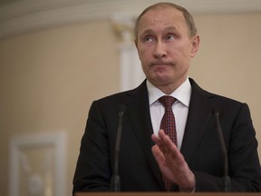 Russias President Vladimir Putin reacts as he speaks to the media after a summit aimed at ending 10 months of fighting in Ukraine in Minsk on February 12, 2015. Putin said that he and the leaders of France, Germany and Ukraine had agreed on the withdrawal of heavy weapons from Ukraine's frontlines and a ceasefire to begin from February 15. AFP PHOTO / POOL / ALEXANDER ZEMLIANICHENKOALEXANDER ZEMLIANICHENKO/AFP/Getty Images