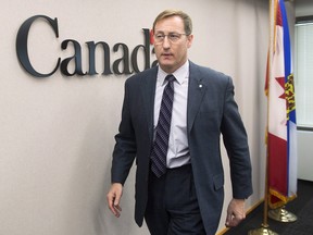 Justice Minister Peter MacKay heads from a news conference, regarding a foiled mass murder plan, in Halifax on Saturday, Feb. 14, 2015. MacKay said the plot to carry out the killings in a public place was not linked to terrorism.