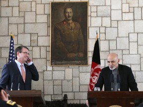 U.S. Defense Secretary Ash Carter, left,  listens to remarks by Afghan President Ashraf Ghani during a news conference at the Presidential Palace in Kabul, Afghanistan, Saturday, Feb. 21, 2015.  Carter made his international debut Saturday with a visit to Afghanistan to see American troops and commanders, meet with Afghan leaders and assess whether U.S. withdrawal plans are too risky to Afghan security.  (SAP Photos/Jonathan Ernst, Pool)