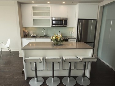 Crisp white cabinets, a large island and clean lines define the kitchen.