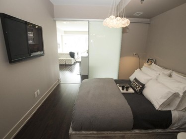 A frosted sliding door lets in lots of light to the master bedroom.