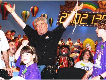 Max Keeping celebrates after the Childrens Miracle Network Telethon raised 2,402,130 dollars. On the right is 13-year old co-host Joshua Fry.