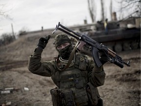 A Ukrainian soldier gestures as he guards territory near Debaltseve, eastern Ukraine on Sunday, Feb. 8, 2015. The Ukrainian government has complained that its forces are outgunned by the separatists, who have deployed advanced Russian weaponry such as rocket launchers and tanks. NATO and Ukraine say Russian soldiers are also fighting in Ukraine.