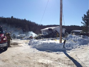 Aftermath of fire in Gracefield, Que., where provincial police confirmed they removed two bodies from the charred home.