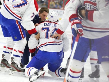 Alexei Emelin of the Montreal Canadiens is taken off the ice early in the game against the Ottawa Senators during first period NHL action.