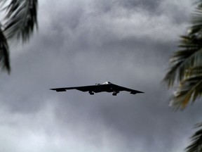 A B-2 Spirit strategic bomber conducts a low approach training flight over Hickam Air Force Base, Hawaii April 2, 2014.  Two B-52 Stratofortress strategic bombers from Barksdale Air Force Base, La. and two B-2 Spirit strategic bombers from Whiteman Air Force Base, Mo., flew non-stop from their respective home stations to training ranges within the vicinity of Hawaii and conducted range training operations and low approach training flights at Hickam AFB. (U.S. Marine Corps photograph by Staff Sgt. Jason W. Fudge // RELEASED)