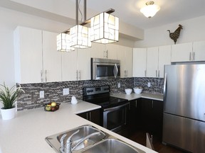 Upgrades in the Beringer kitchen include the backsplash, eating bar and stained-glass light fixture, plus the U-shape configuration. The standard kitchen is an L with and island.