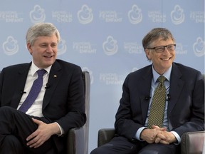 Canadian Prime Minister Stephen Harper and Bill Gates smile as they are introduced during a moderated discussion in Ottawa, Wednesday February 25, 2015.