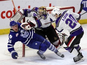 Binghamton Senators' G Scott Greenham (35) is interfered with by Marlies' Sam Carrick (16) during an AHL game at Canadian Tire Centre in Ottawa, Sunday, February 15, 2015.