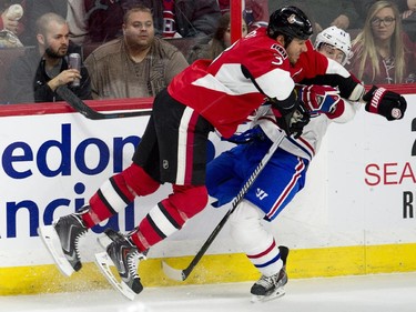 Ottawa Senators defenseman Marc Methot collides with Montreal Canadiens right wing Brendan Gallagher along the boards during second period NHL action.