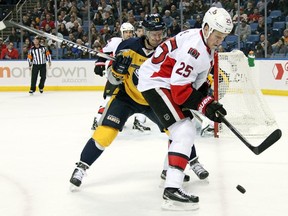 Buffalo Sabres' Torrey Mitchell (17) battles for the puck against Ottawa Senators' Chris Neil (25) during the first period of an NHL hockey game Tuesday, Feb. 10, 2015, in Buffalo, N.Y.