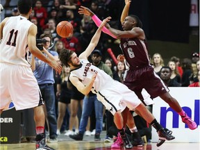 Caleb Agada, right, of the University of Ottawa Gee-Gees collides with Gavin Resch of the Carleton Ravens during first-quarter action of the MBNA Capital Hoops Classic held at the Canadian Tire Centre on Friday, Feb. 06, 2015.