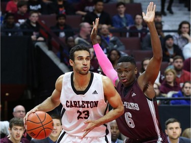 Caleb Agada, right, of the University of Ottawa guards Philip Scrubb of the Carleton University men's basketball team without success during first quarter action.