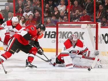 Cam Ward #30 of the Carolina Hurricanes makes a save against a scoring chance by Clarke MacArthur #16 of the Ottawa Senators.