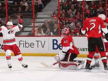 Chris Terry #25 and Andrej Nestrasil #15 of the Carolina Hurricanes celebrate a second period goal against Robin Lehner #40 and Jared Cowen #2 of the Ottawa Senators.