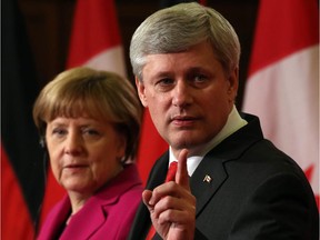 Prime Minister Stephen Harper and German Chancellor Angela Merkel hold a joint news conference on Parliament Hill in Ottawa on Monday, February 6, 2015.