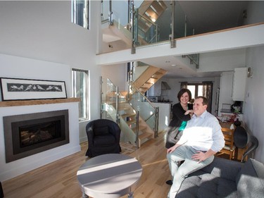The third-floor living room is a bright and cosy spot for owners Chantal Rioux and Nicolas Delahousse. Behind them are the stairwell, rustic table that doubles as an at-home desk and kitchen, while above is the 16-foot ceiling and loft. Not visible are the loft’s couches, mini-fridge and big-screen television — a perfect retreat from a clamorous world.