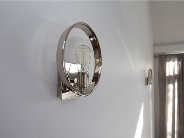 Uptown Theatre Row Wall Sconce from Living Lighting Ottawa ($192). Rioux selected the lights for the living room because she liked their blend of contemporary silver design and the exposed CFL bulb with its traditional “Edison” look.