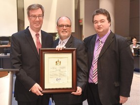 Chris Taylor receives the Mayor's City Builder Award from Mayor Jim Watson, left, and College ward Coun. Rick Chiarelli.