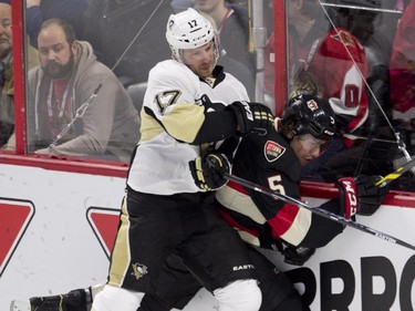 Pittsburgh Penguins left wing Blake Comeau sends Ottawa Senators defenseman Cody Ceci into the boards during first period NHL action Thursday February 12, 2015 in Ottawa.