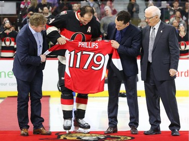 Left to right: Daniel Alfredsson, Chris Phillips, Wade Redden and Bryan Murray celebrate Phillips' 1179 start as an Ottawa Senators prior to the game.