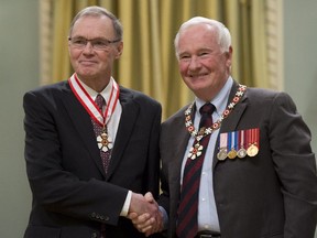 Governor General David Johnston invests Donald McRae, from Ottawa, as a Companion of the Order of Canada during a ceremony at Rideau Hall in Ottawa on Friday, February 13, 2015.