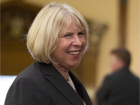 Deb Matthews makes her way through the legislature as she prepares to be sworn in as president of the Treasury Board at Queens Park in Toronto on Tuesday June 24, 2014.