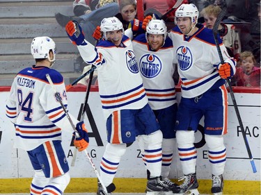 Edmonton Oilers' Derek Roy (8) celebrates after scoring against the Ottawa Senators with teammates Oscar Klefbom, left to right, Nail Yakupov, and Justin Schultz during first period NHL hockey action in Ottawa on Saturday, Feb. 14, 2015.