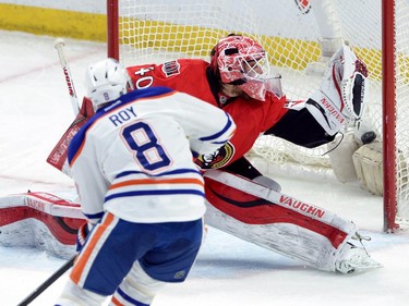 Edmonton Oilers' Derek Roy, left, scores on Ottawa Senators goalie Robin Lehner during first period NHL hockey action in Ottawa on Saturday, Feb. 14, 2015.
