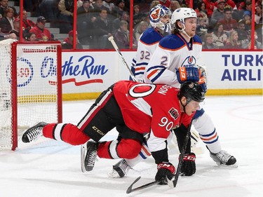 OTTAWA, ON - FEBRUARY 14: Alex Chiasson #90 of the Ottawa Senators falls to the ice as he battles with Jeff Petry #2 of the Edmonton Oilers for position in the second period at Canadian Tire Centre on February 14, 2015 in Ottawa, Ontario, Canada.