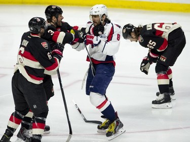 Ottawa Senators right wing Bobby Ryan and Marc Methot take exception with Washington Capitals left wing Alex Ovechkin after he hit Senators Erik Karlsson, right, along the boards during second period NHL action.