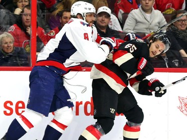 Erik Karlsson of the Ottawa Senators is hit by Alex Ovechkin of the Washington Capitals during first period NHL action.