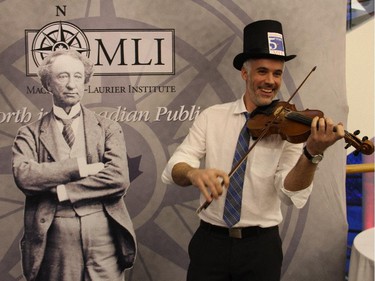 Fiddler Matt Pepin, seen next to the Sir John A Macdonald cutout, performed at a special dinner hosted by the Macdonald-Laurier Institute on Wednesday, February 18, 2015, at the Canadian Museum of History to celebrate the 200th anniversary of Macdonald's birthdate.