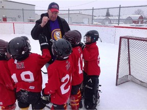 Head coach Dave Burke leads his Weiner Division (ages 5-7) players Josh Adamson (left to right), Josh Bradley, Ryder Burns, Will Adamson and Fergus Neave through a pre-game cheer.