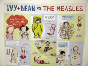 A poster educating parents and children about measles is displayed at the Tamalpais Pediatrics clinic Friday, Feb. 6, 2015, in Greenbrae, Calif.