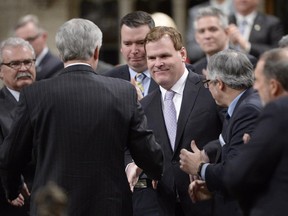 Foreign Minister John Baird is congratulated in the House of Commons in Ottawa on Tuesday, Feb. 5, 2015 after announcing his resignation.