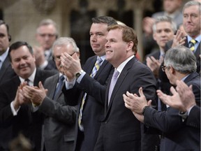 Foreign Minister John Baird receives a standing ovation in the House of Commons in Ottawa on Tuesday, Feb. 5, 2015. Baird announced his resignation.
