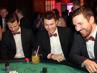 From left, Ottawa Senators players Alex Chiasson, Curtis Lazar and Andrew Hammond try their luck at the blackjack table during the Ferguslea Senators Soirée held at the Hilton Lac Leamy on Wednesday, February 4, 2015.