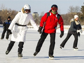 Ruth and Walter Skof hold hands as they skate along the Rideau Canal Skateway on Friday.
