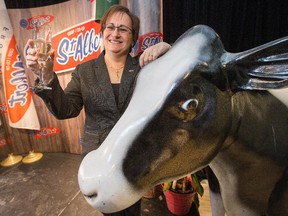 Ginette Quesnel, President of the St Albert Cheese Co-Op has a glass of champagne with mascot "Albertine" as the store opened officially to the public following a devastating fire two years ago that destroyed the store and factory. Assignment - 119716 Photo taken at 12:25 on February 3. (Wayne Cuddington/Ottawa Citizen)