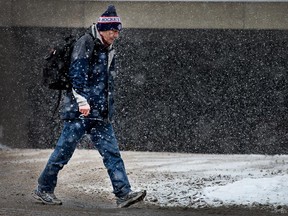 Greg Crosby crosses Daly Ave as the region experienced more snow.