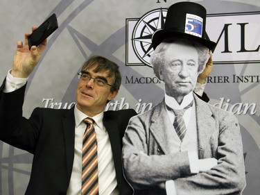 Guests, like journalist John Robson, were encouraged to Tweet selfies of themselves with a Sir John A Macdonald cutout on display at a special event organized by the Macdonald-Laurier Institute on Wednesday, February 18, 2015.