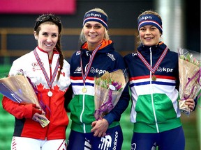 Silver medallist Ivanie Blondin of Ottawa poses with gold medallist Irene Schouten of the Netherlands, centre, and bronze medallist Mariska Huisman of the Netherlands after the mass start race in Hamar, Norway, on Sunday, Feb. 1, 2015.