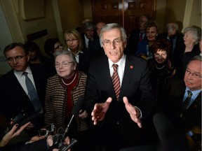James Cowan, flanked by other newly declared Independent Senators, speaks to reporters on Parliament Hill in Ottawa on Wed., January 29, 2014, following Liberal leader Justin Trudeau's announcement to remove senators from the caucus.