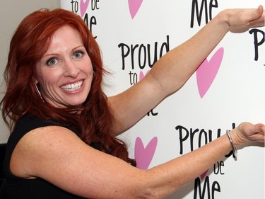 Jen Brisebois from the Proud to be Me board strikes a fun pose in front of the banner wall at the organization's benefit dinner for youth empowerment and acceptance, held at NeXT restaurant on Monday, February 23, 2015.