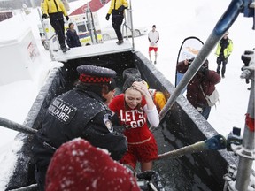 Jennifer-Anne Gibson tries to warm up after taking the Polar Plunge in support of Special Olympics athletes, at TD Place on Saturday.