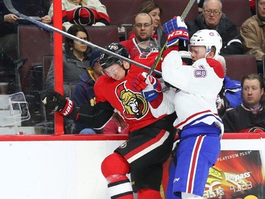 Jiri Sekac of the Montreal Canadiens hits Curtis Lazar of the Ottawa Senators during first period NHL action.