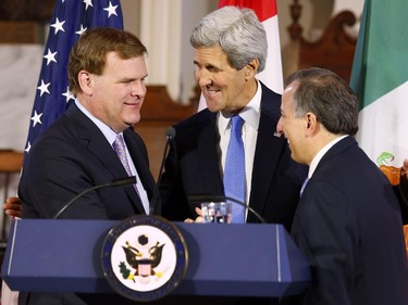 2015: U.S. Secretary of State John Kerry, center, hugs Canadian Foreign Minister John Baird, left, and Mexican Foreign Secretary Jose Antonio Meade after a news conference at Faneuil Hall in Boston Saturday, Jan. 31, 2015.